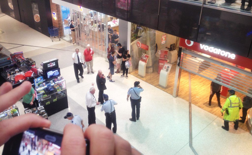 People filmed and photographed the incident as police worked. People filmed and photographed the incident as police worked.